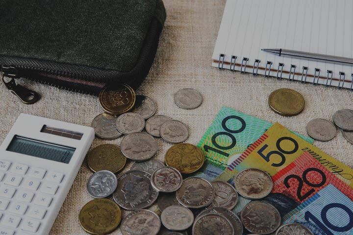 Australian currency, a calculator, a pen and a notepad.