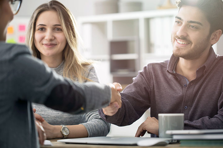 A couple meeting a professional financial planner.